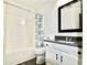 Clean bathroom, featuring a tub shower, vanity, and dark framed mirror at 2555 Flat Shoals Rd # 3005, South Fulton, GA 30349