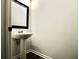 Small bathroom with pedestal sink and dark framed mirror at 2555 Flat Shoals Rd # 3005, South Fulton, GA 30349