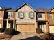 Attractive townhome exterior with two-car garage and landscaping at 3335 Castleberry Village Cir, Cumming, GA 30040