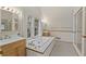 Bright bathroom features a luxurious soaking tub, double vanity, and black and white patterned tile flooring at 1703 Noble Ne Dr, Atlanta, GA 30306