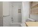 Clean bathroom with white subway tile, shower/tub combo and window at 2343 Meadow Dr, Snellville, GA 30078