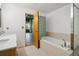 Bathroom with bathtub, double vanity, and glass block window at 3235 Roswell Ne Rd # 716, Atlanta, GA 30305