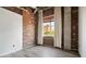 Bedroom with exposed brick wall, large window, and hardwood floors at 3235 Roswell Ne Rd # 716, Atlanta, GA 30305