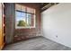 Bedroom with exposed brick wall and large window at 3235 Roswell Ne Rd # 716, Atlanta, GA 30305