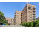 Brick building with multiple balconies and a gated parking area at 3235 Roswell Ne Rd # 716, Atlanta, GA 30305