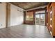 Large living area with hardwood floors, exposed brick wall, and access to balcony at 3235 Roswell Ne Rd # 716, Atlanta, GA 30305