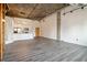 Spacious living area with exposed ductwork and brick wall, hardwood floors and large windows at 3235 Roswell Ne Rd # 716, Atlanta, GA 30305
