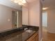 Bathroom features granite vanity, sink, and mirrored medicine cabinet at 199 14Th Ne St # 1209, Atlanta, GA 30309