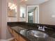 Bathroom with granite countertop, stainless steel sink, and tiled shower at 199 14Th Ne St # 1209, Atlanta, GA 30309