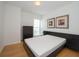 Spacious bedroom with hardwood floors and two framed art pieces at 199 14Th Ne St # 1209, Atlanta, GA 30309