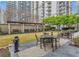 Courtyard with pergola, tables, chairs and manicured lawn at 199 14Th Ne St # 1209, Atlanta, GA 30309