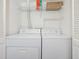 Laundry closet with washer, dryer, and shelving at 199 14Th Ne St # 1209, Atlanta, GA 30309