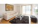 Bright living room with hardwood floors, white couch, and access to a balcony at 199 14Th Ne St # 1209, Atlanta, GA 30309