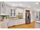 Modern kitchen with white cabinets, stainless steel appliances, and tile backsplash at 3053 Hudson Way, Decatur, GA 30033