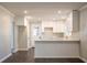 Modern white kitchen with an island and hardwood floors at 3377 Bobolink Cir, Atlanta, GA 30311