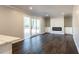 Open living room with hardwood floors, fireplace, and sliding glass doors at 3377 Bobolink Cir, Atlanta, GA 30311