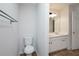 Bright bathroom featuring a toilet, vanity with double sinks, and a large mirror at 5665 Terremont Cir, Norcross, GA 30093