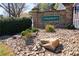 Stone entrance to Terremont community featuring manicured landscaping and decorative rock at 5665 Terremont Cir, Norcross, GA 30093