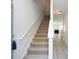 Bright entryway with stairs leading up, and view of living room and kitchen at 5665 Terremont Cir, Norcross, GA 30093