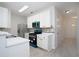Well-lit kitchen featuring white cabinets, stainless steel appliances, and eye-catching blue accents at 5665 Terremont Cir, Norcross, GA 30093