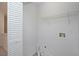 A functional laundry room featuring hookups, shelving, and louvered door at 5665 Terremont Cir, Norcross, GA 30093