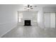 Living room features a black fireplace, ceiling fan, and two windows with natural light at 5665 Terremont Cir, Norcross, GA 30093