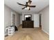 Main bedroom with ceiling fan, dresser, and access to other rooms at 5863 Wintergreen Rd, Norcross, GA 30093