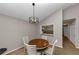 Bright dining area with a charming wooden table and built-in kitchen pass-through at 5863 Wintergreen Rd, Norcross, GA 30093