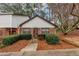 Brick front exterior of charming townhome with well-manicured landscaping at 5863 Wintergreen Rd, Norcross, GA 30093