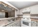 Updated kitchen boasting granite countertops and stylish light fixtures at 5863 Wintergreen Rd, Norcross, GA 30093