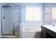 Bathroom with shower, bathtub, and white subway tile at 912 Tanners Point Dr, Lawrenceville, GA 30044