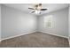 Bright bedroom with ceiling fan and neutral carpeting at 4642 Mahonia Nw Way, Acworth, GA 30102