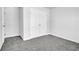 Simple bedroom with gray carpet and double doors to closet at 4101 Fulson Dr, Lilburn, GA 30047