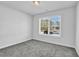 Bright bedroom featuring gray carpet, neutral walls, and a window offering natural light at 4101 Fulson Dr, Lilburn, GA 30047