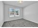 Cozy bedroom with neutral walls, carpet flooring, and a window providing natural light at 4101 Fulson Dr, Lilburn, GA 30047