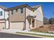 Two-story townhome boasting tan brick and light beige vinyl siding, and a 2-car garage at 4101 Fulson Dr, Lilburn, GA 30047