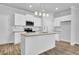 Bright kitchen with stainless steel microwave, white cabinets, granite countertops, and island at 4101 Fulson Dr, Lilburn, GA 30047