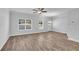 Bright living room with ceiling fan, two windows and wood-look flooring at 4101 Fulson Dr, Lilburn, GA 30047