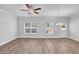 Bright living room with ceiling fan, two windows and wood-look flooring at 4101 Fulson Dr, Lilburn, GA 30047