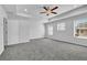 Main bedroom with ceiling fan, carpet, and multiple windows at 4101 Fulson Dr, Lilburn, GA 30047