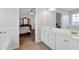 Bright bathroom featuring double vanity with white cabinets and bedroom peek-a-boo at 661 Towering Pine Se Trl, Lawrenceville, GA 30045