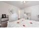 White-themed bedroom features heart mirror, dresser, and vanity setup at 661 Towering Pine Se Trl, Lawrenceville, GA 30045