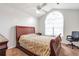 Bedroom with large window, ceiling fan, and classic wood furniture at 661 Towering Pine Se Trl, Lawrenceville, GA 30045