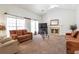 Bright living room with large windows, comfortable sofas, a fireplace, and neutral-toned carpet at 661 Towering Pine Se Trl, Lawrenceville, GA 30045