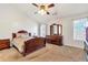 Spacious main bedroom with a ceiling fan, dual windows, and carpeted flooring at 661 Towering Pine Se Trl, Lawrenceville, GA 30045