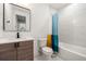 Modern bathroom with bathtub, shower, and wood vanity at 130 Wesley Place, Fayetteville, GA 30214