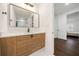 Modern bathroom with light wood vanity and a large mirror at 130 Wesley Pl, Fayetteville, GA 30214