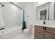 Modern bathroom with white marble and wood vanity at 130 Wesley Place, Fayetteville, GA 30214