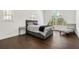 Bedroom with a large triangular window and dark hardwood floors at 130 Wesley Place, Fayetteville, GA 30214