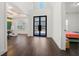 Bright and airy foyer with dark hardwood floors and modern black doors at 130 Wesley Place, Fayetteville, GA 30214